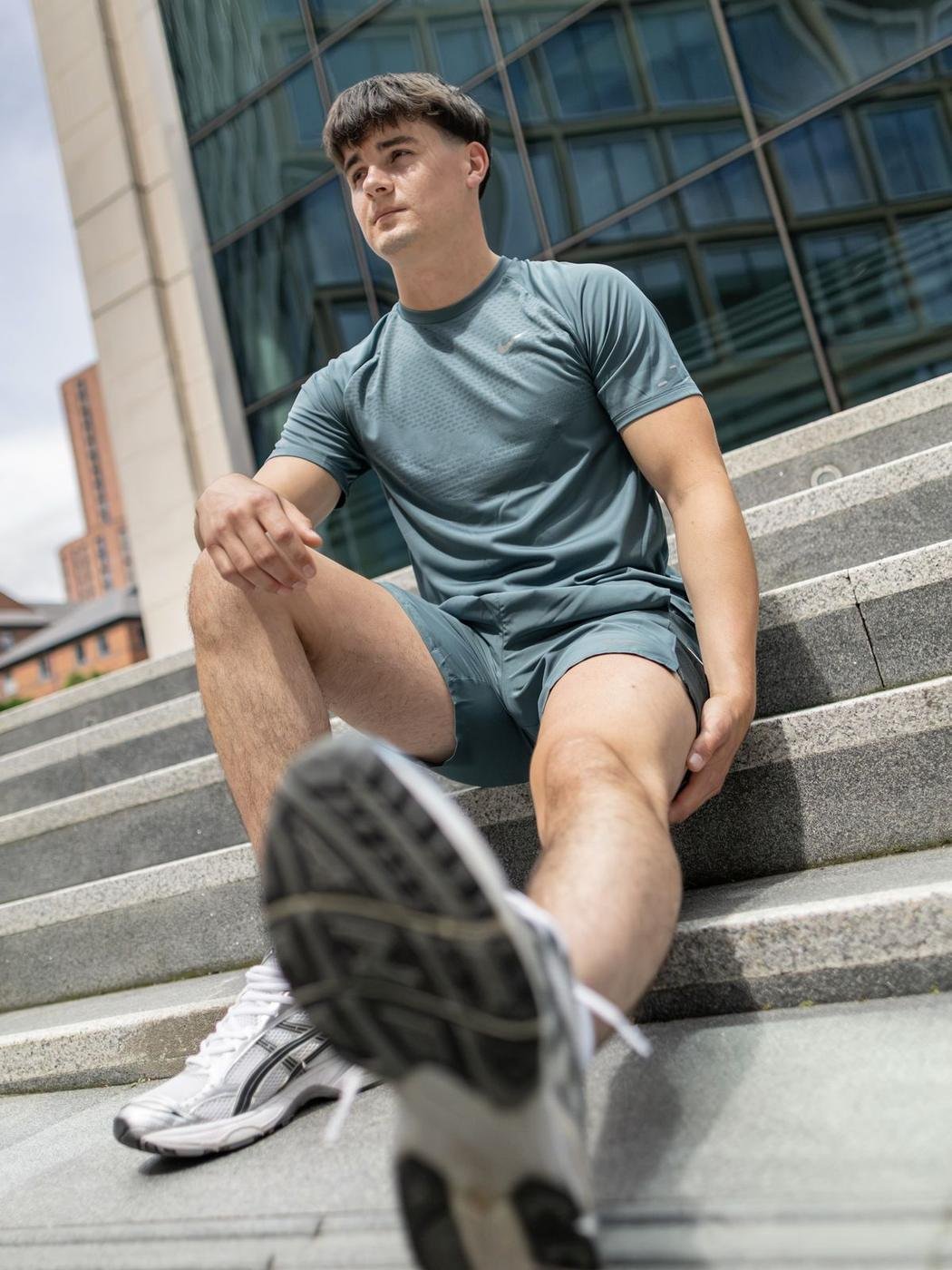 Model in activewear on outdoor steps